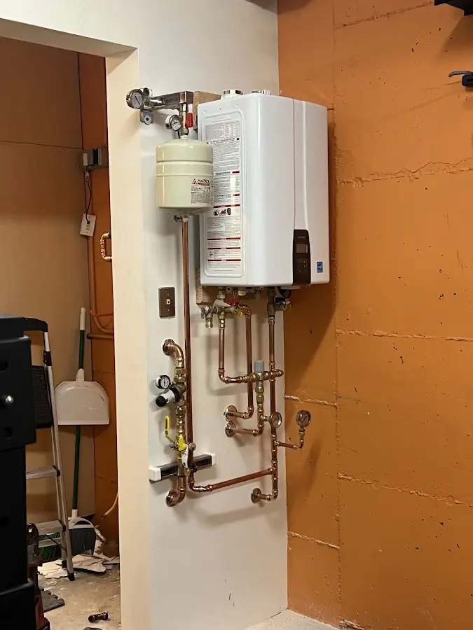 Plumbing technician inspecting water heater connections in Isle of Palms